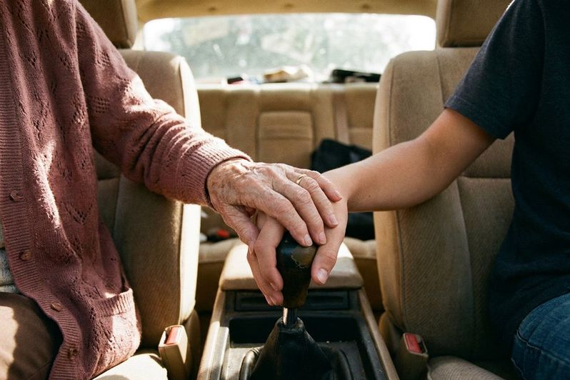 Her hand over his on the gear shift